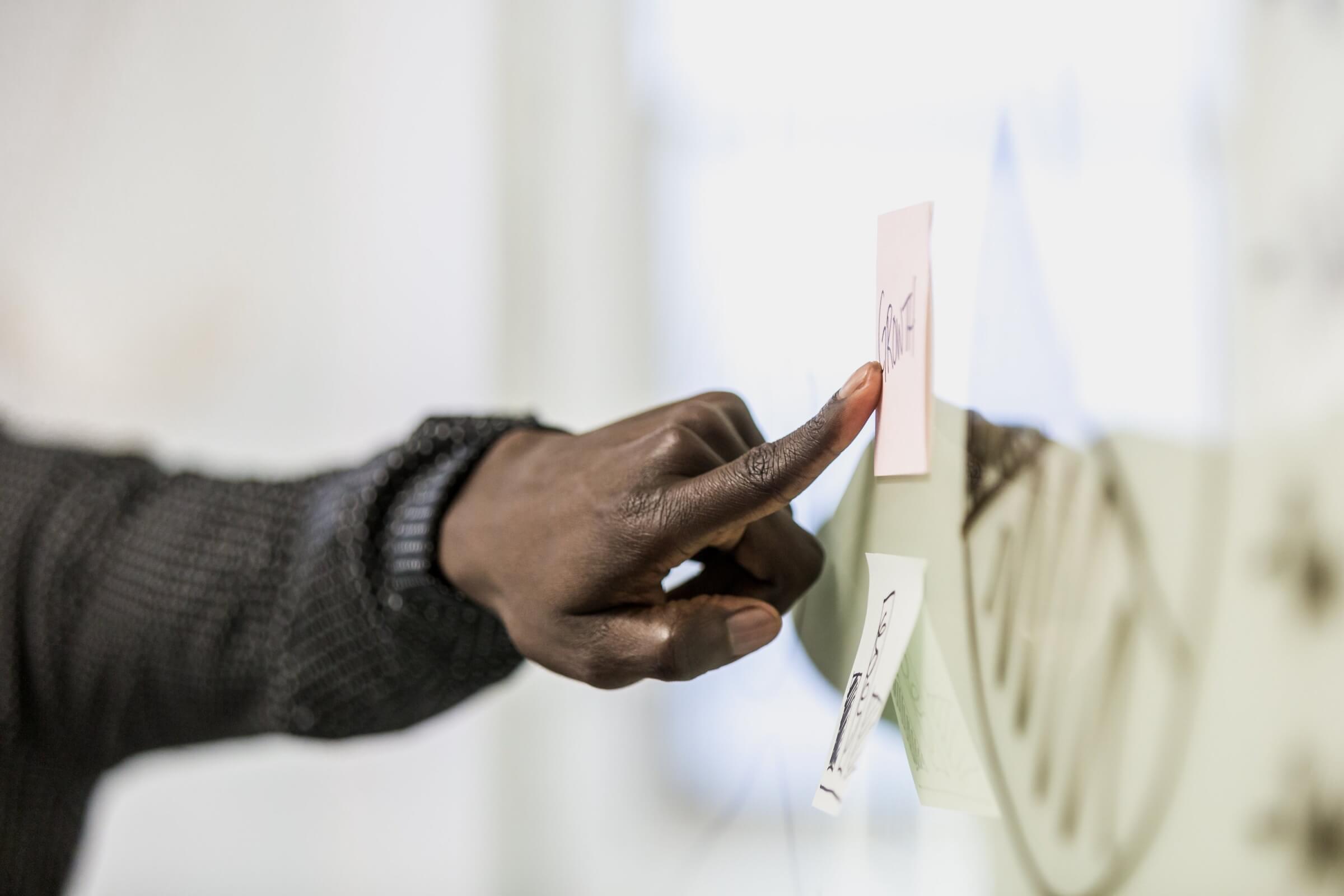 hand pointing at a whiteboard