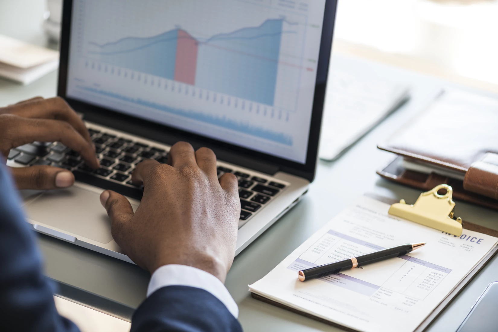 A product manager reviewing business data on their laptop.